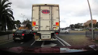 Truck Drives into Stationary Car at Roundabout