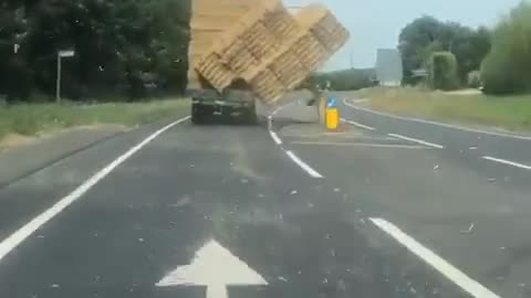 Truck Carrying Bales Of Hay Overturns After Losing Balance