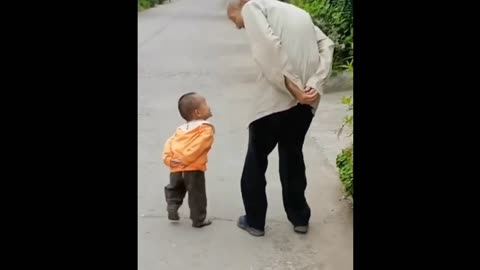 A cute child copy his grandfather 😁