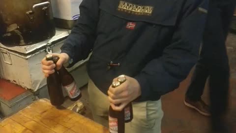 Guy black shirt opening beer in slomo