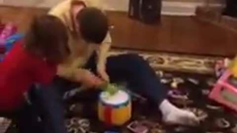 Son trying out his niece's drum she received as a Christmas Present