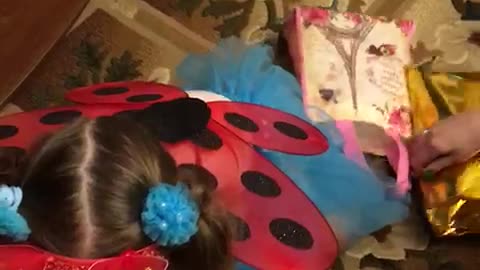 A little girl enjoys gifts for Christmas