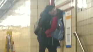 Couple making out at subway station