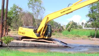 Bulldozer cleaning river