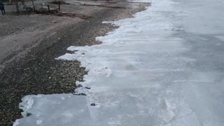 Creeping Ice Washes onto Shoreline