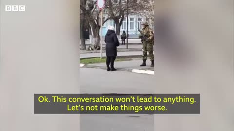 Ukrainian woman confronts armed Russian soldier - BBC News