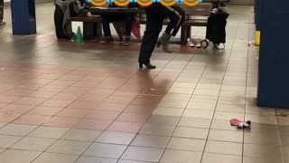 Man dances to "she's a bad mama jama' in heels in a subway station