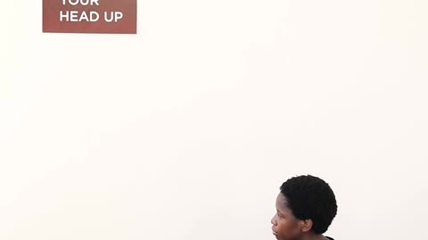 A Woman Looking at a Sign while Sitting on the Floor