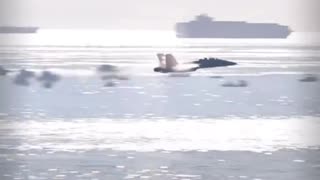 Amazing slo-mo tracking shot of a vapor cone forming around a transonic F-18.