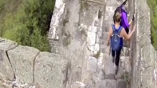 Two bricklayers demolish the great wall of china with an excavator