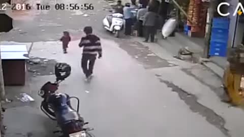 Car passes over a child on the street