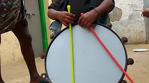 Cute boy playing with drums