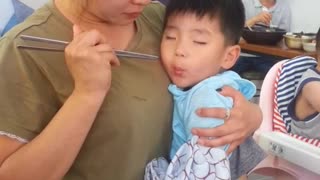 Toddler can't decide between sleeping and eating