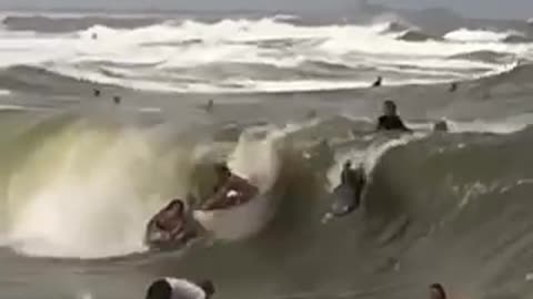 Bunch of surfers run into each other in barrel of wave