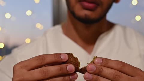 Man Eating Falafel