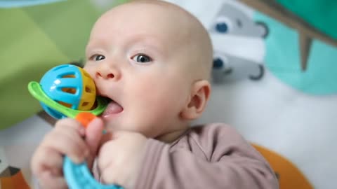 cute Baby Biting A Toy