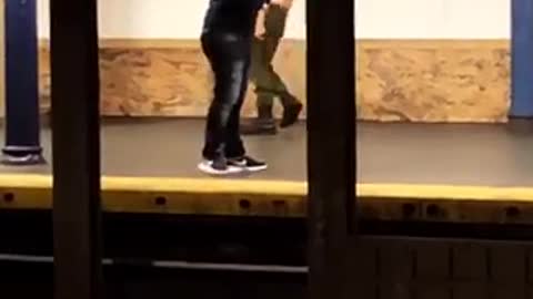 Shirtless man walks back and forth in subway station