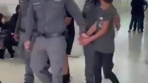 A Palestinian boy asks his family for a jacket as the Israeli forces take him