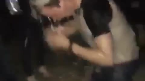 Guy white shirt getting beer spilled on him