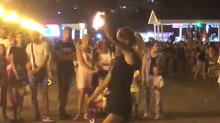 girl performs a fire show
