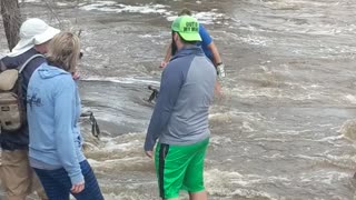 Man Crosses Dangerous, Flooded Bridge
