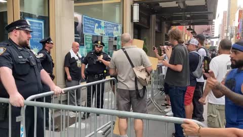 NEW YORKERS Try to stop parents entering toddler vax site 42nd Street 6th July