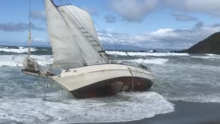 Sailboat stuck on shore beach water