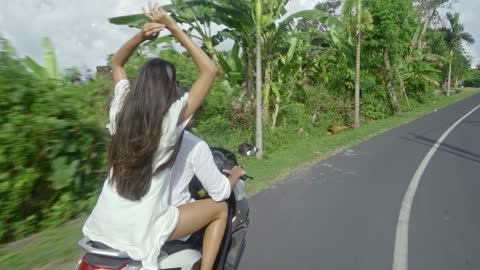 A Couple Riding A Motorcycle In A Road Trip To The Countryside