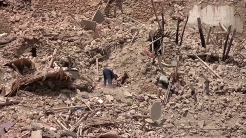 Moroccans search for belongings in the rubble of houses