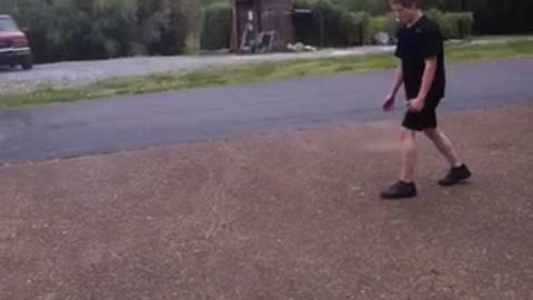 Black shirt kid tries to frontflip from pavement to grass