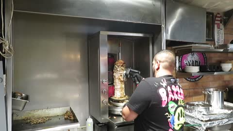 Shawarma! Watch as they load up the pita bread. Walk with me, Steve Martin