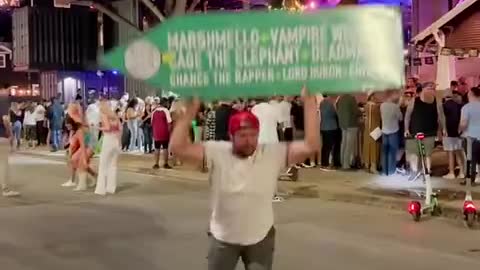 Street performers dancing with billboards...