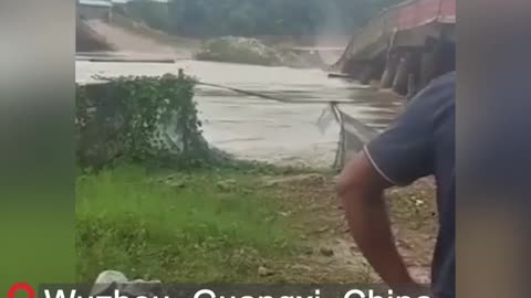 Floodwaters destroyed a bridge in Wuzhou City, Guangxi Province