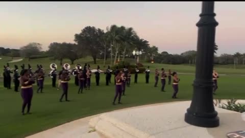 President Trump reviews the marching band performing at his annual Super Bowl party