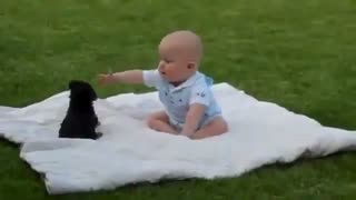 The cutest baby playing with a puppy