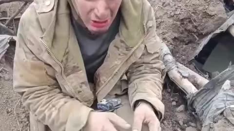 Russians take an Ukrainian RPG gunner prisoner and calming him down