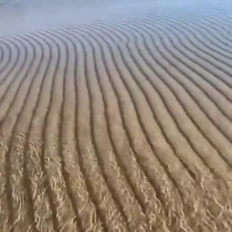 Water rippling over sand