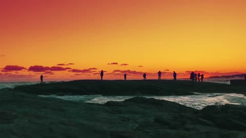 People at the seaside at sunset