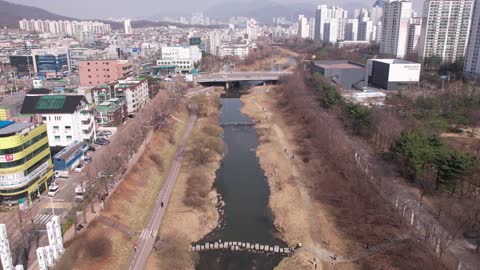 Time Labs drone view racing along the stream in the city