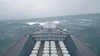 Navy ship battles huge waves at sea