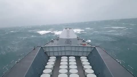 Navy ship battles huge waves at sea