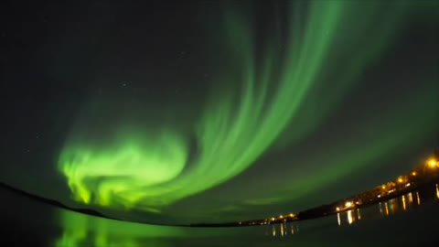 Majestic Northern Lights and Their Reflections on Lake’s Surface