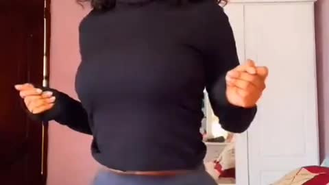 cute girl dances with her smart hips.