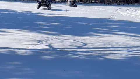 Husky Joins Daughter for ATV Pulled Sled Ride