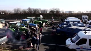 Armored police block French farmers on highway to Paris