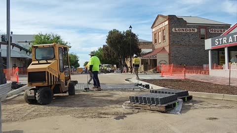 Robotec machine laying pavers