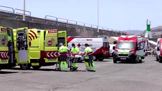 Red Cross workers help rescued migrants in Spain