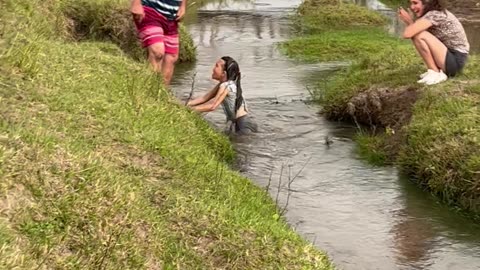 Family Fails to Help Daughter Across Stream