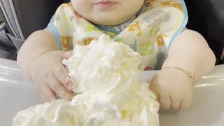 Baby Confused by First Encounter With Whipped Cream