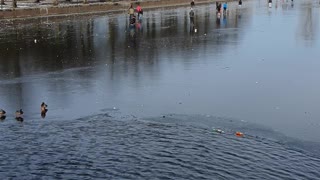 frozen amsterdam canals and people skating